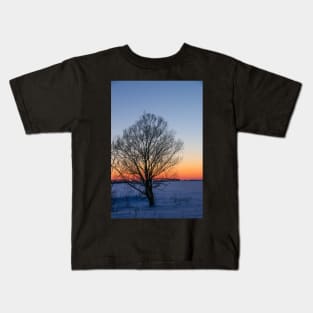 Sunset winter landscape with snow-covered road in violet and pink colors Kids T-Shirt